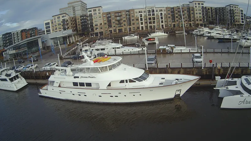 Slide: The Image of 1988 Christensen Custom yacht docked in marina, surrounded by buildings. - 6