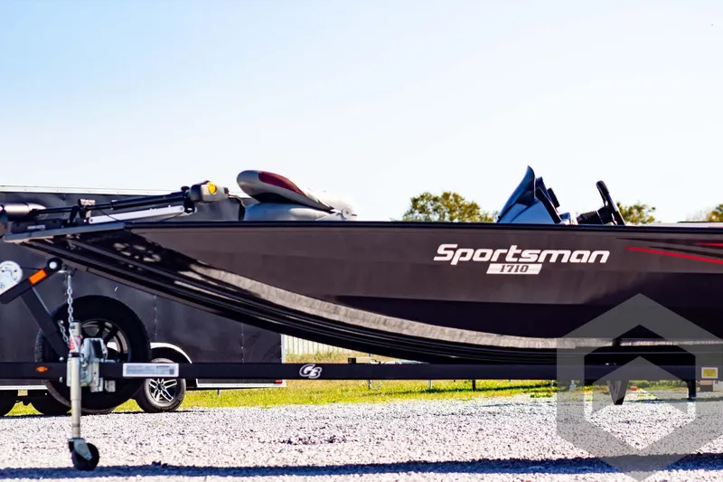 Slide: The Image of 2025 G3 Sportsman 1710 boat on trailer, parked outdoors. - 13