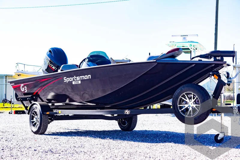 Slide: The Image of 2025 G3 Sportsman 1710 boat on trailer, sleek black design, outdoor setting. - 16