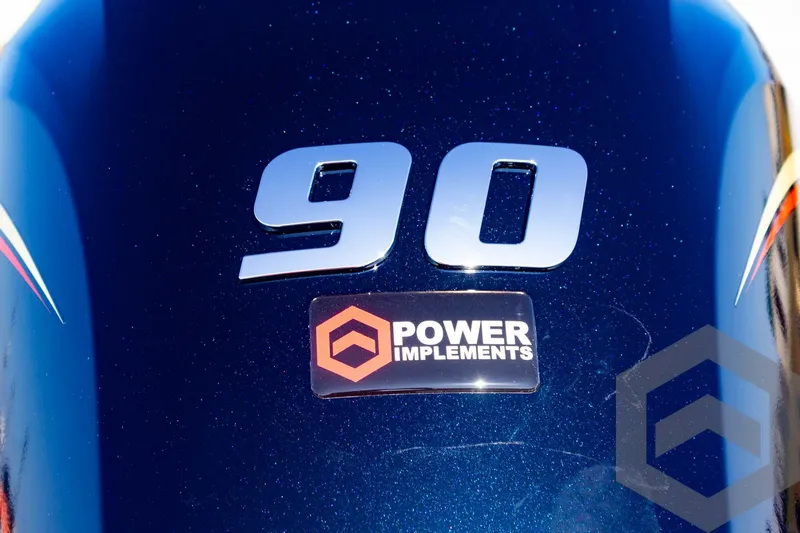 Slide: The Image of Close-up of 2025 G3 Sportsman 1710 engine with "90" and "Power Implements" logo. - 28