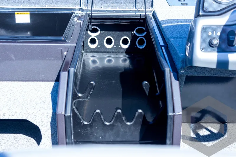 Slide: The Image of 2025 G3 Sportsman 1710 boat storage compartment with rod holders and cup holders. - 43