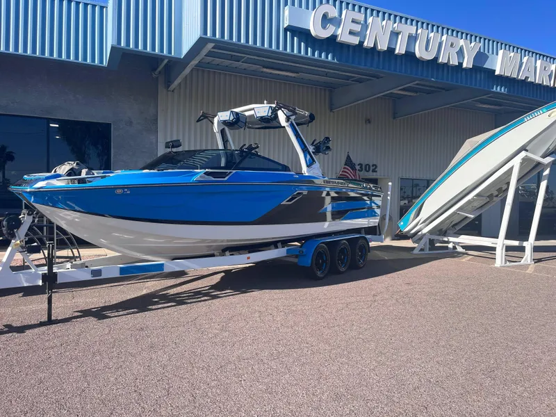 Slide: The Image of 2022 Centurion Ri265 boat on trailer outside Century Marine dealership. - 1