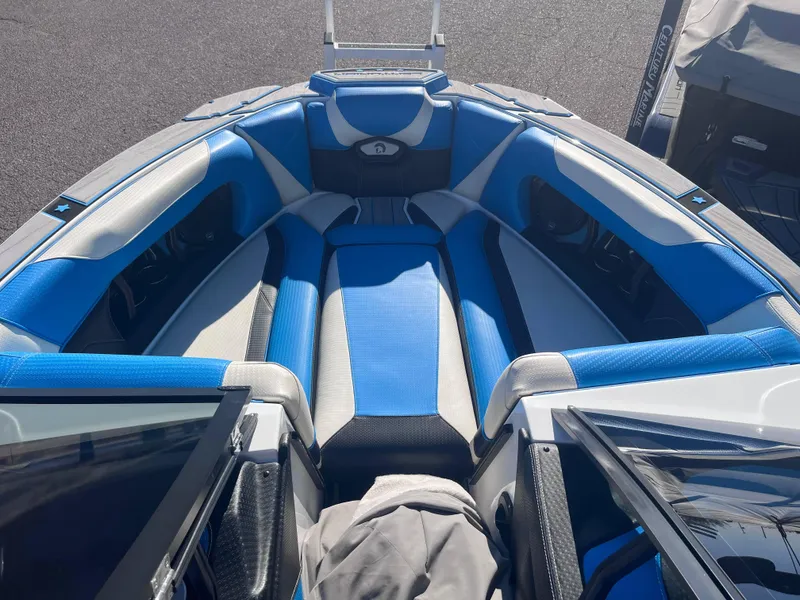 Slide: The Image of 2022 Centurion Ri265 boat interior with blue and gray seating. - 10