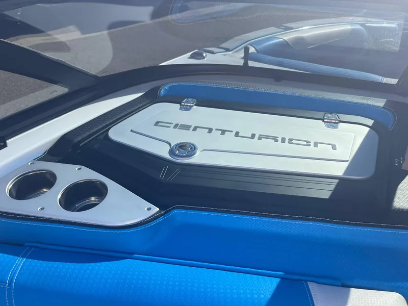 Slide: The Image of 2022 Centurion Ri265 boat interior with branded engine cover and cup holders. - 11