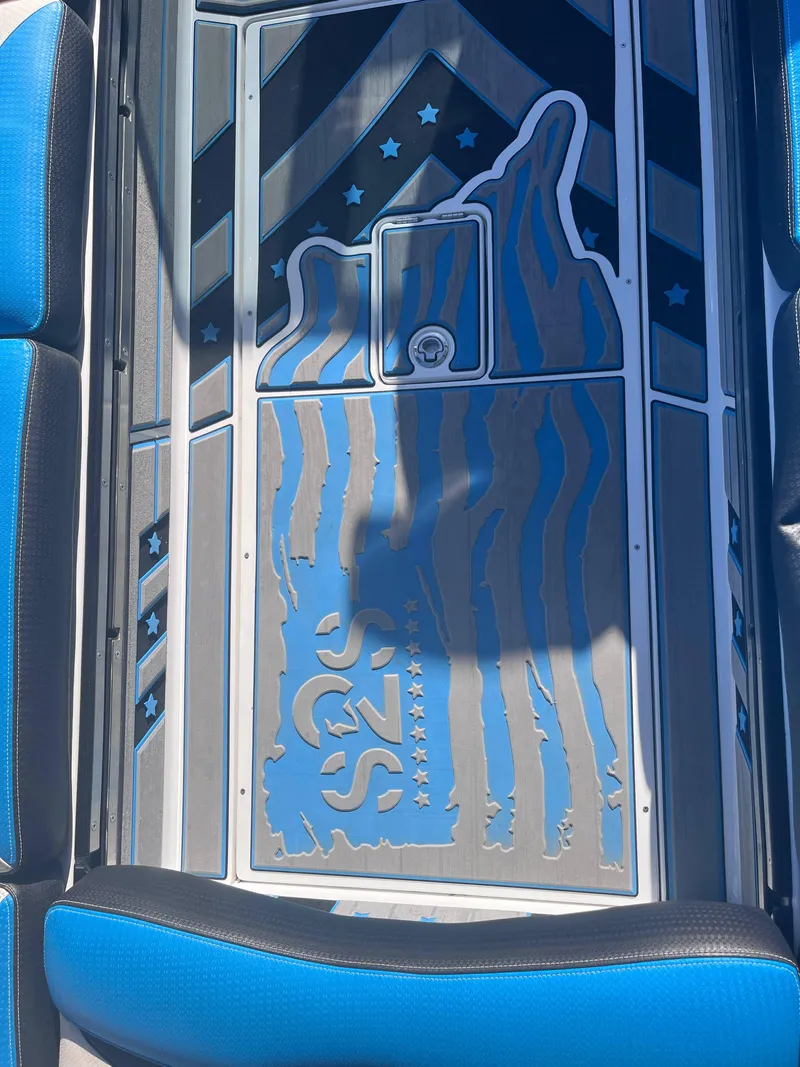 Slide: The Image of 2022 Centurion Ri265 boat interior with custom blue and gray flooring design. - 13