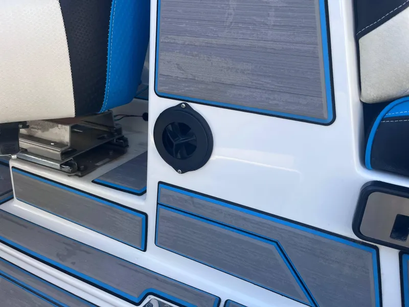 Slide: The Image of 2022 Centurion Ri265 boat interior with blue-accented seating and speaker detail. - 15