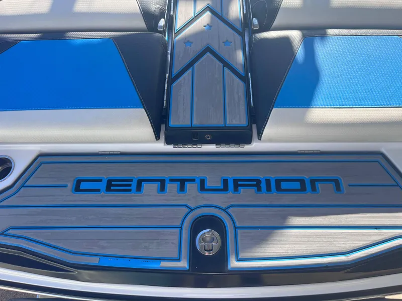 Slide: The Image of 2022 Centurion Ri265 boat deck with blue and gray design. - 16