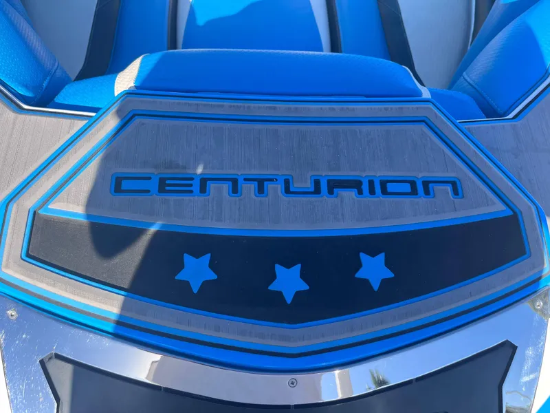 Slide: The Image of 2022 Centurion Ri265 boat deck with blue accents and star design. - 18