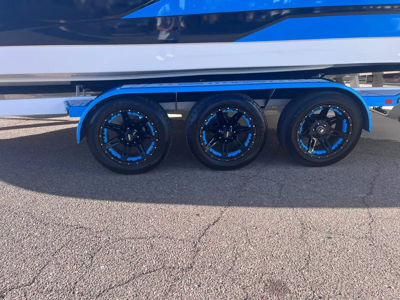 Slide: The Image of 2022 Centurion Ri265 boat trailer with blue and black wheels. - 20