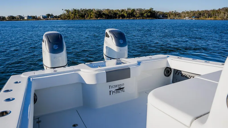 Slide: The Image of Freeman 34VH 2020 boat with twin engines on a serene lake. - 12