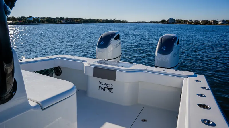 Slide: The Image of Freeman 34VH 2020 boat on calm water, featuring dual engines and spacious deck. - 13