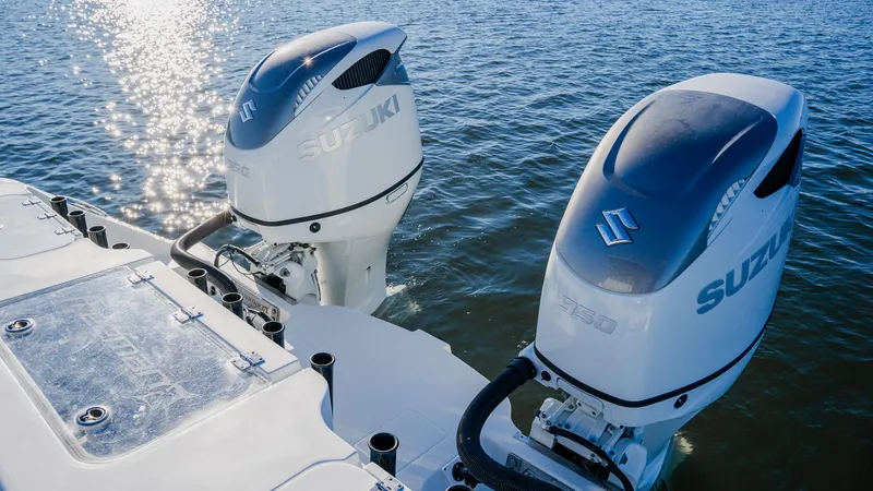 Slide: The Image of Freeman 34VH 2020 boat with dual Suzuki outboard motors on water. - 14