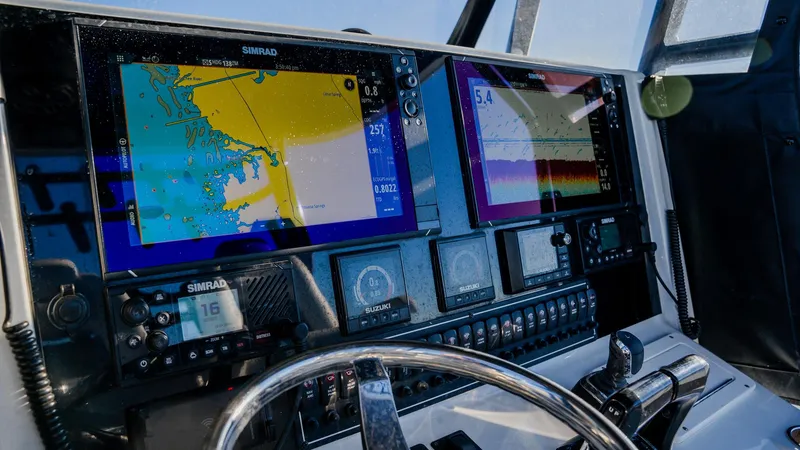 Slide: The Image of Freeman 34VH 2020 boat dashboard with navigation screens and controls. - 19