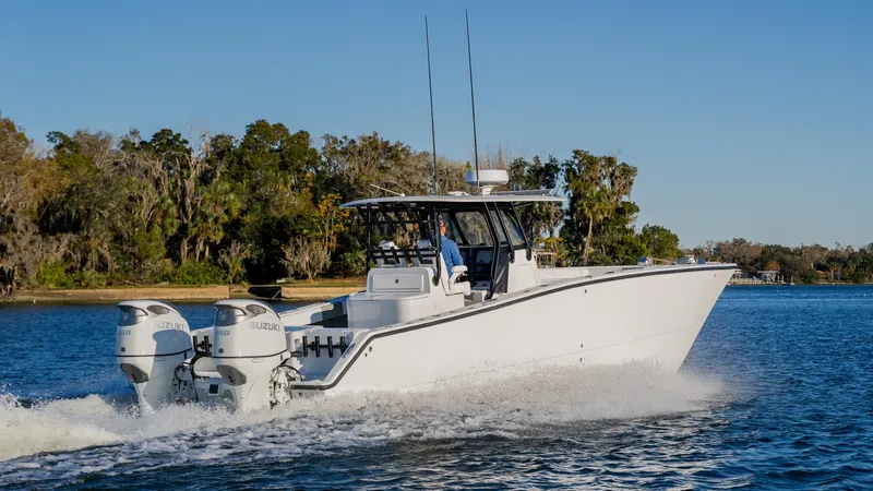 Slide: The Image of 2020 Freeman 34VH boat cruising on a lake with twin engines. - 5