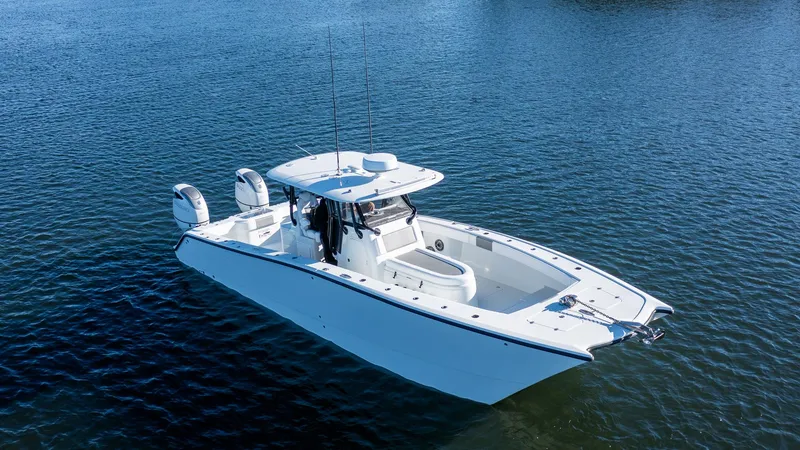 Slide: The Image of 2020 Freeman 34VH boat on calm water, featuring dual engines and spacious deck. - 8