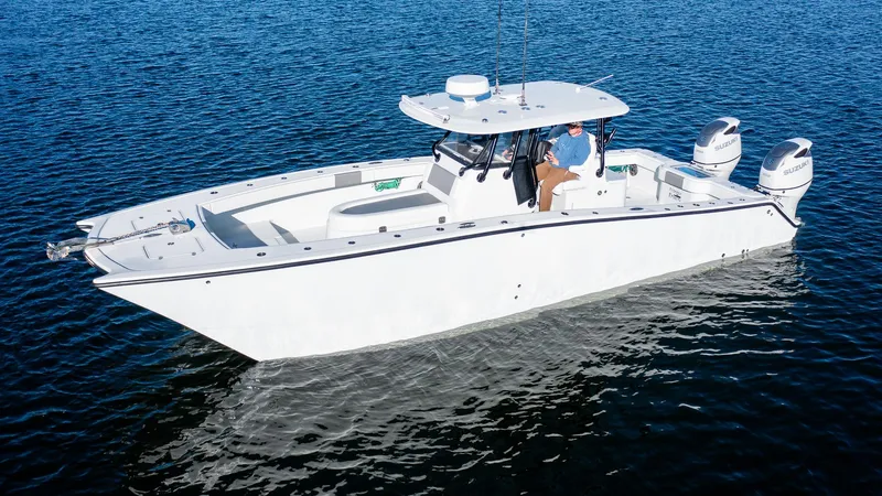 Slide: The Image of 2020 Freeman 34VH boat on calm water, featuring dual outboard motors. - 9
