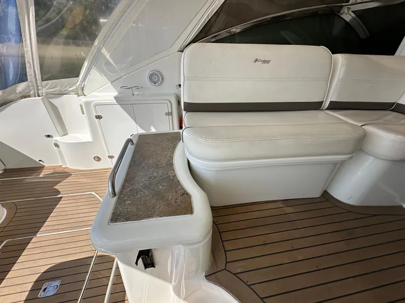 Slide: The Image of 2009 Cruisers Yachts 420 Express interior with white seating and wood flooring. - 11