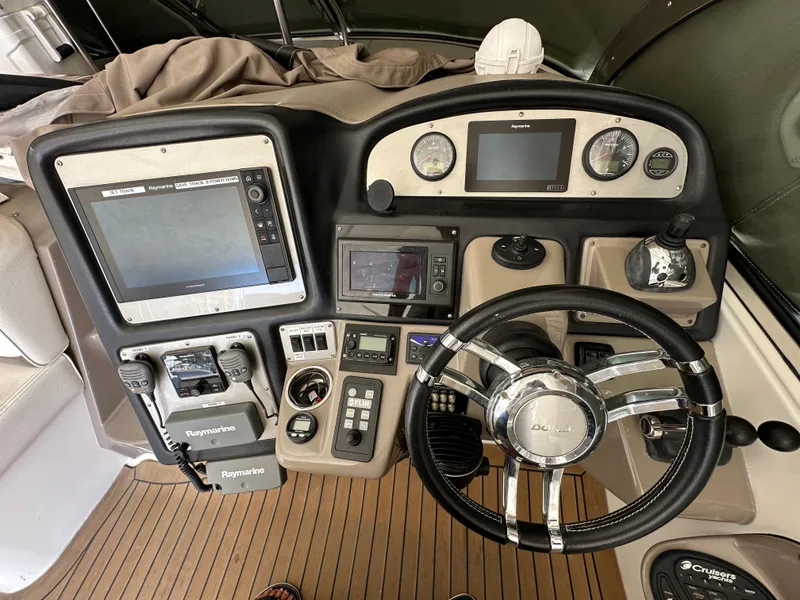 Slide: The Image of Dashboard of 2009 Cruisers Yachts 420 Express with navigation and control instruments. - 12
