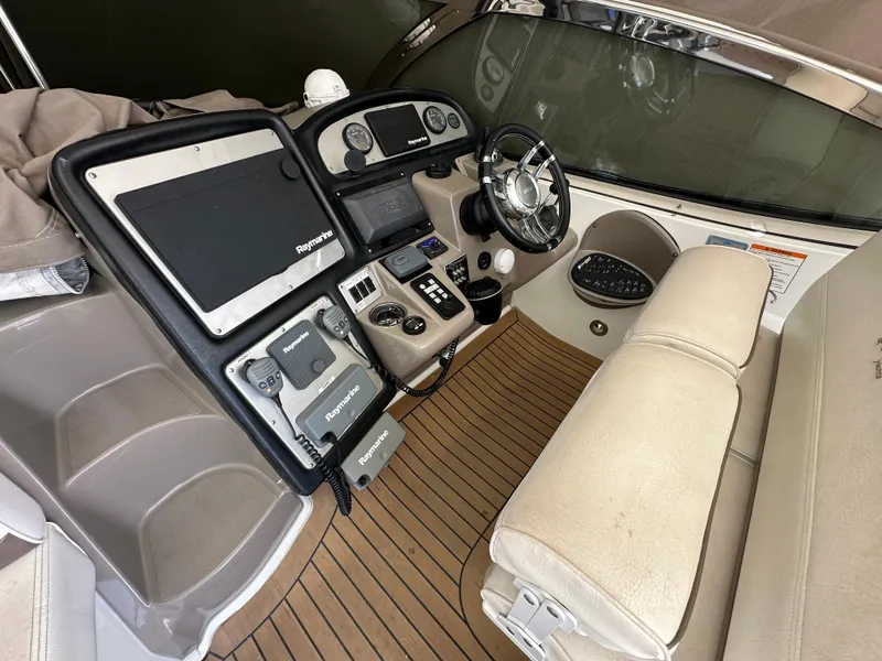 Slide: The Image of 2009 Cruisers Yachts 420 Express helm with advanced navigation equipment and luxurious seating. - 13