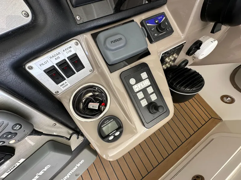 Slide: The Image of Control panel of 2009 Cruisers Yachts 420 Express with navigation and communication equipment. - 14