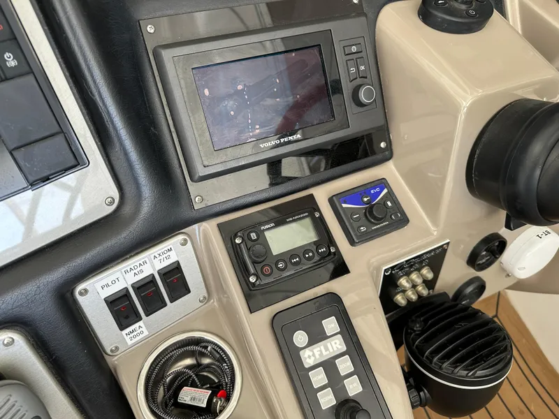 Slide: The Image of Control panel of 2009 Cruisers Yachts 420 Express with navigation and communication equipment. - 15