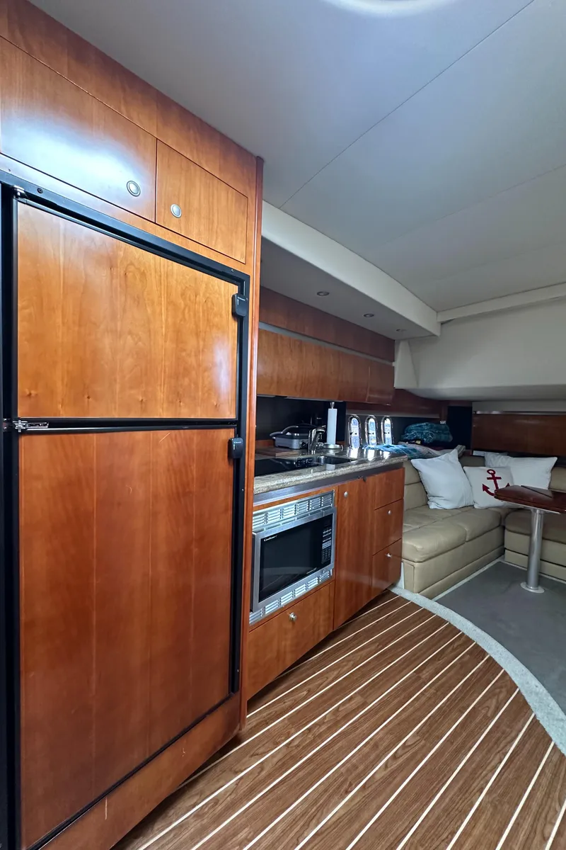 Slide: The Image of 2009 Cruisers Yachts 420 Express interior with kitchen and seating area. - 24