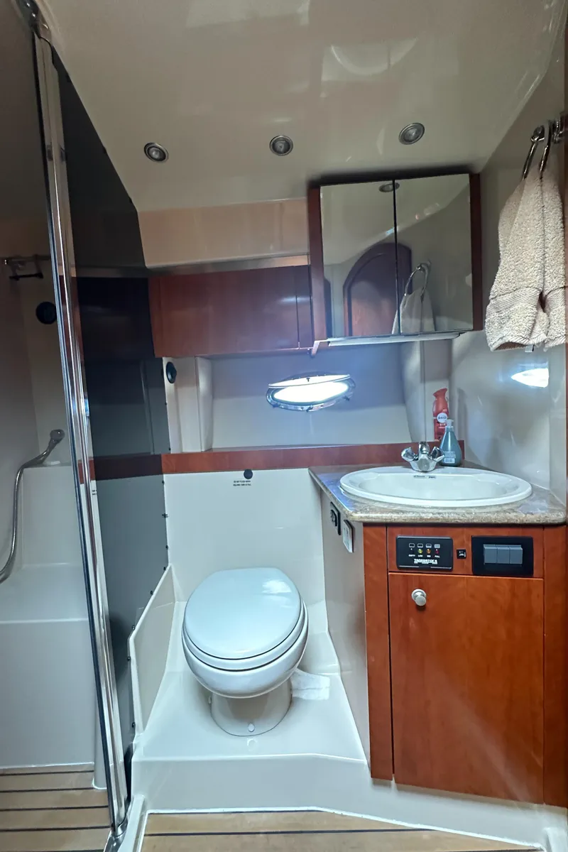 Slide: The Image of 2009 Cruisers Yachts 420 Express bathroom with modern fixtures and wood cabinetry. - 29
