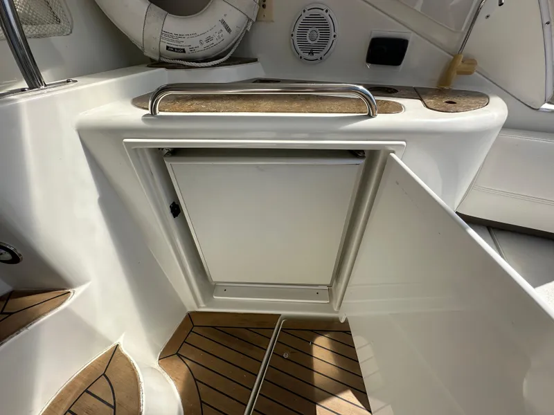 Slide: The Image of 2009 Cruisers Yachts 420 Express interior with open storage and teak flooring. - 7