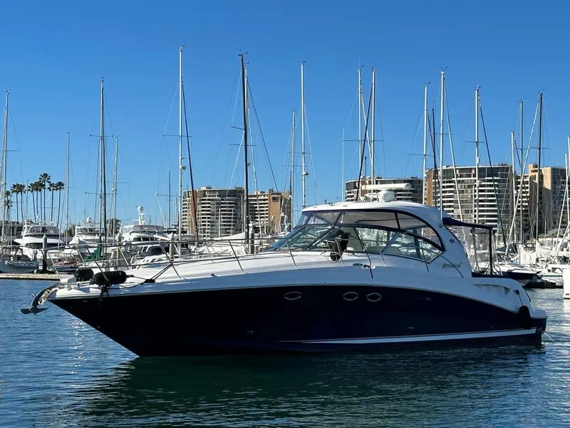 Slide: The Image of 2005 Sea Ray 420 Sundancer yacht docked in marina, clear blue sky. - 1