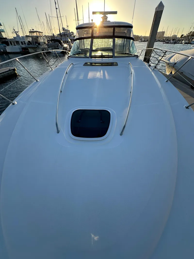 Slide: The Image of 2005 Sea Ray 420 Sundancer yacht docked at sunset, showcasing sleek design and marina backdrop. - 11