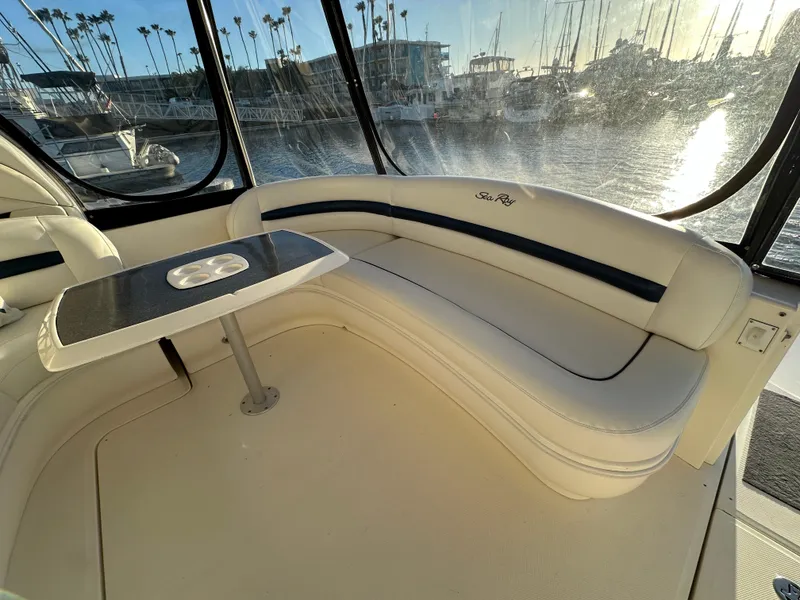 Slide: The Image of Luxurious 2005 Sea Ray 420 Sundancer interior with elegant seating and table, marina view. - 17