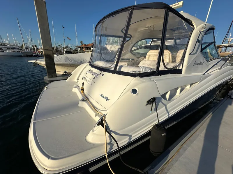 Slide: The Image of 2005 Sea Ray 420 Sundancer docked at marina, featuring sleek design and spacious deck. - 6