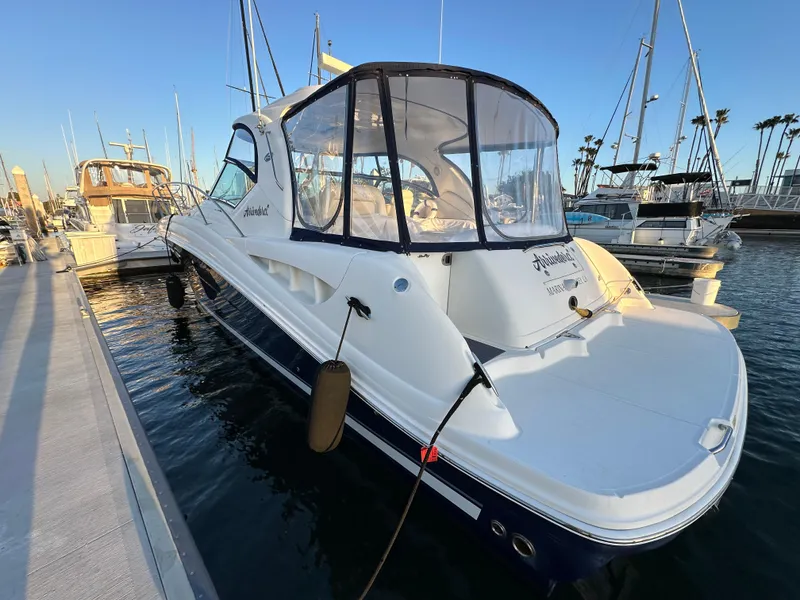Slide: The Image of 2005 Sea Ray 420 Sundancer docked at marina, clear canopy, calm water, sunny day. - 7