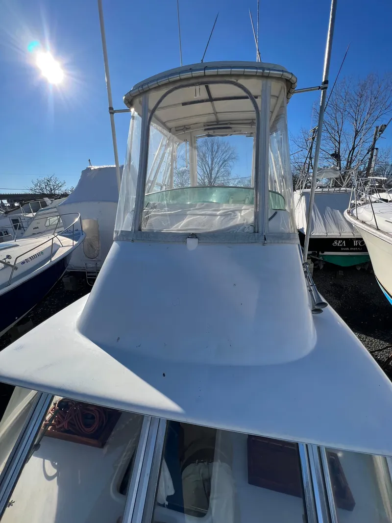 Slide: The Image of 1973 Bertram 31 Flybridge Cruiser under clear blue sky. - 10