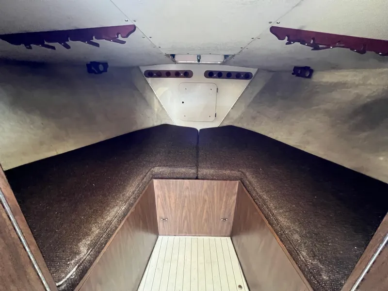 Slide: The Image of Interior cabin of 1973 Bertram 31 Flybridge Cruiser with wood paneling and cushioned seating. - 23