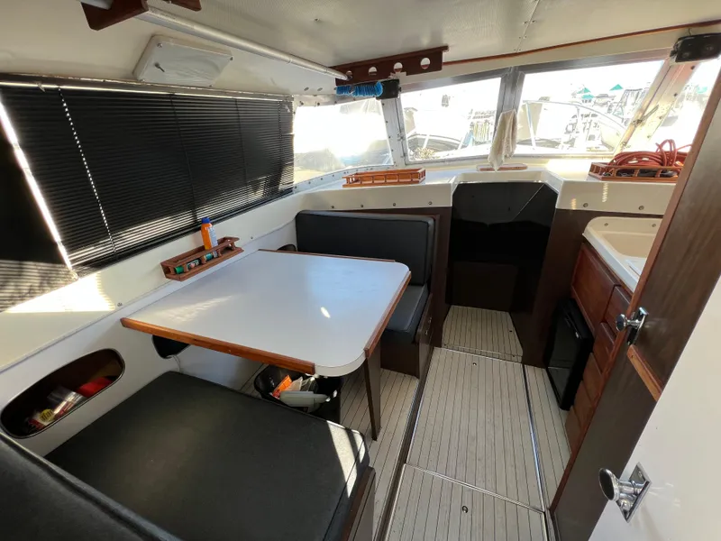 Slide: The Image of Interior of a 1973 Bertram 31 Flybridge Cruiser with seating and table. - 27