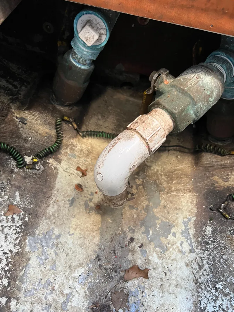 Slide: The Image of 1973 Bertram 31 Flybridge Cruiser plumbing detail with pipes and fittings. - 31