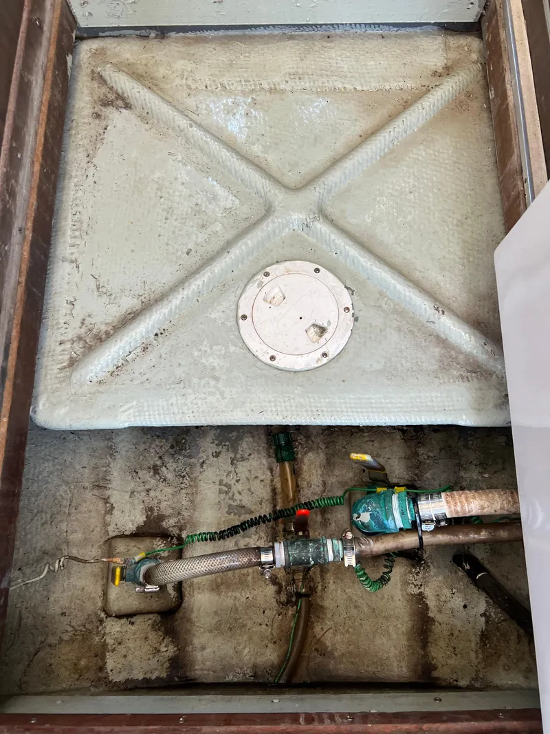 Slide: The Image of 1973 Bertram 31 Flybridge Cruiser fuel tank and plumbing system. - 32