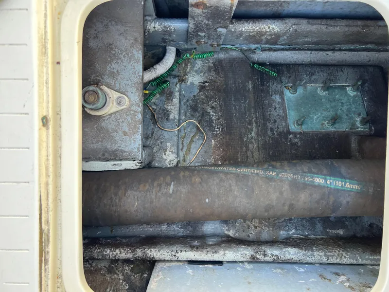 Slide: The Image of Engine compartment of a 1973 Bertram 31 Flybridge Cruiser, showing mechanical components. - 35