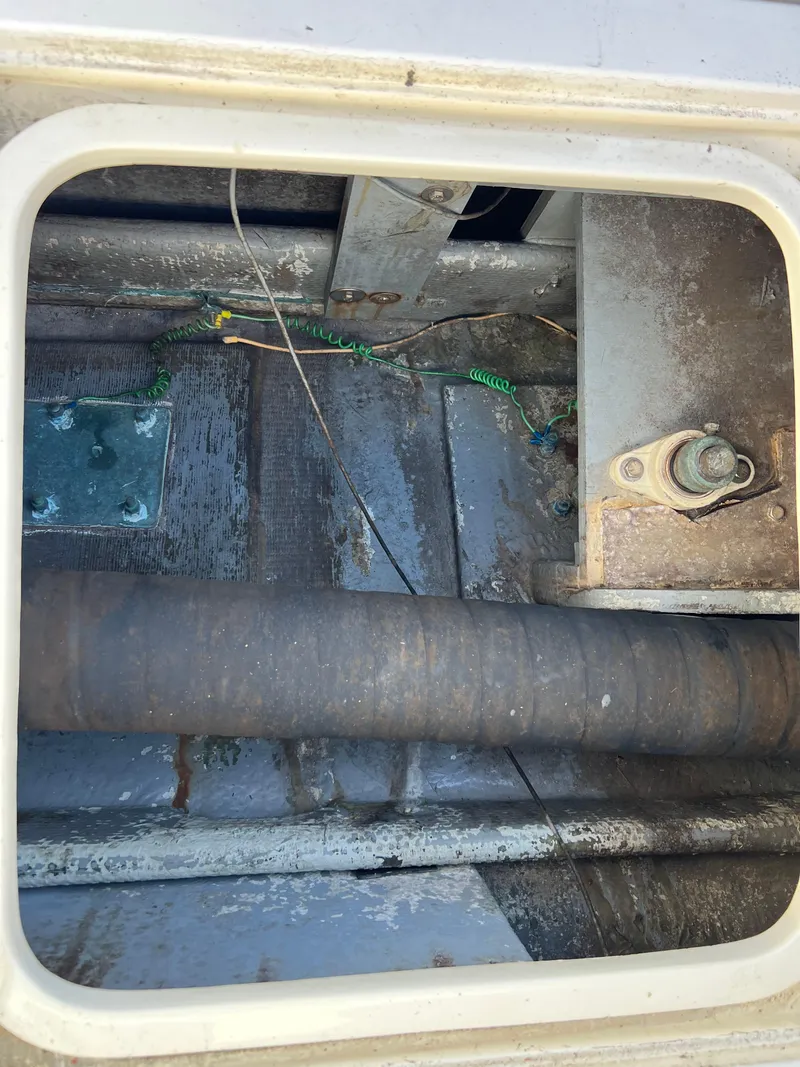 Slide: The Image of Engine compartment of 1973 Bertram 31 Flybridge Cruiser with visible wiring and components. - 38