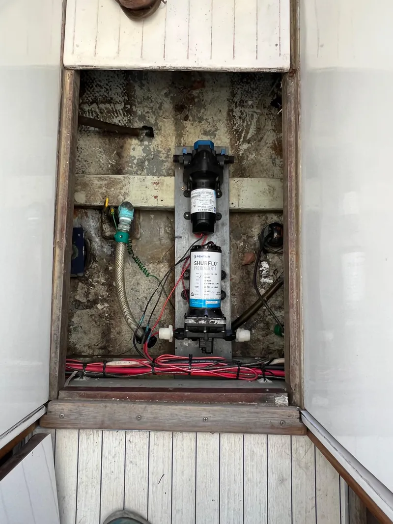 Slide: The Image of 1973 Bertram 31 Flybridge Cruiser bilge area with pump and wiring. - 39