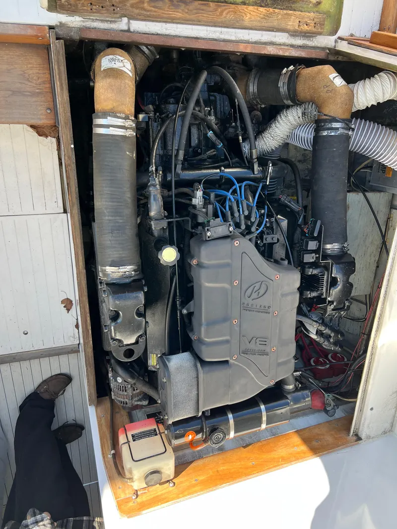 Slide: The Image of 1973 Bertram 31 Flybridge Cruiser engine compartment with visible V8 engine components. - 46