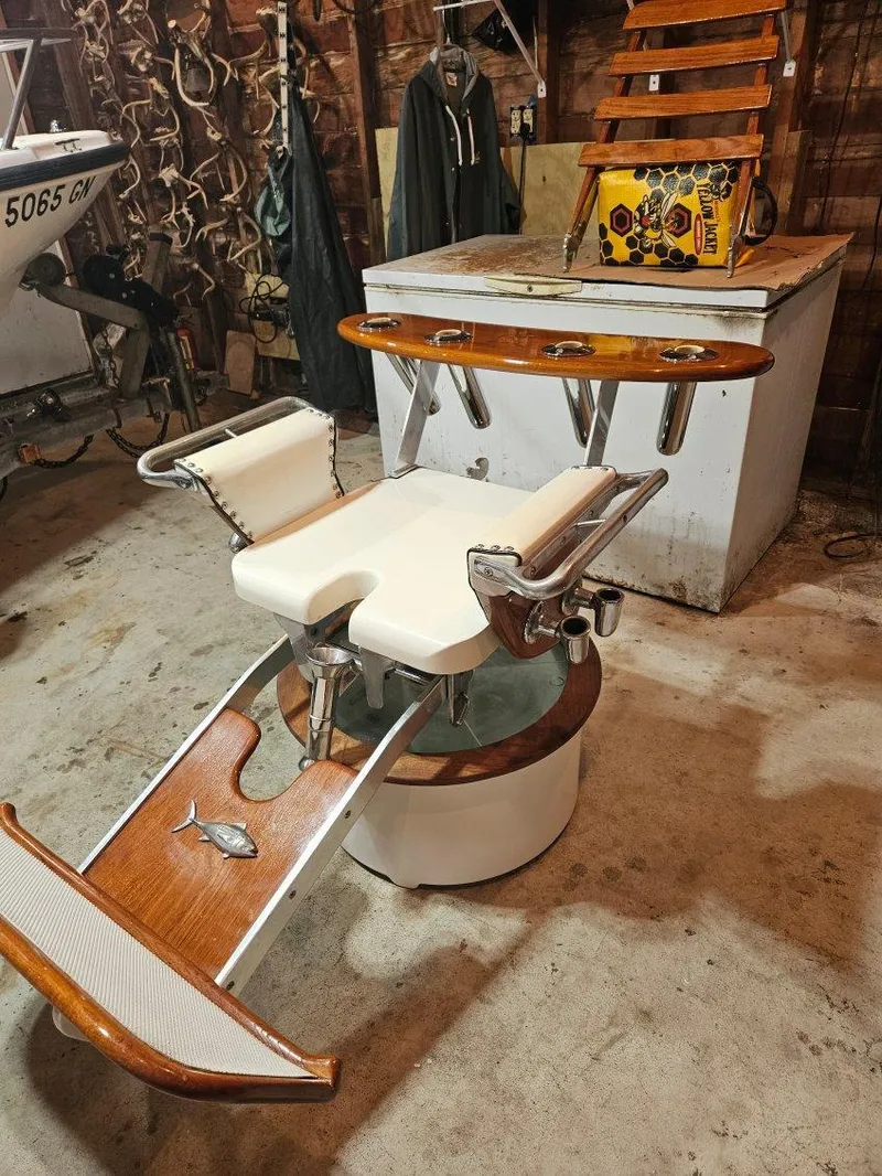 Slide: The Image of Vintage 1973 Bertram 31 Flybridge Cruiser fishing chair in a rustic garage setting. - 48