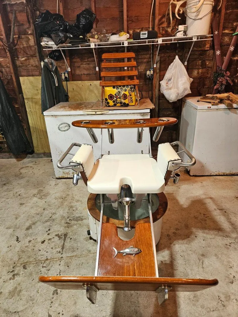 Slide: The Image of 1973 Bertram 31 Flybridge Cruiser fishing chair in a garage setting. - 49