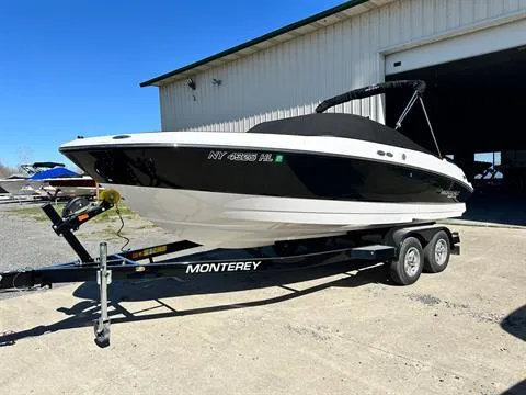 Slide: The Image of 2023 Monterey M-225 boat on trailer outside a warehouse. - 3