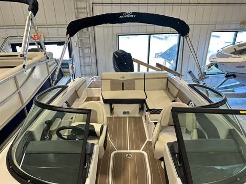 Slide: The Image of 2023 Monterey M-225 boat interior with seating and steering wheel in showroom. - 8