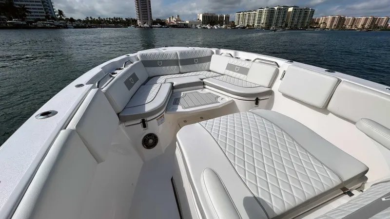 Slide: The Image of 2024 Sea Fox 268 Commander boat with luxurious seating on a calm waterfront. - 10