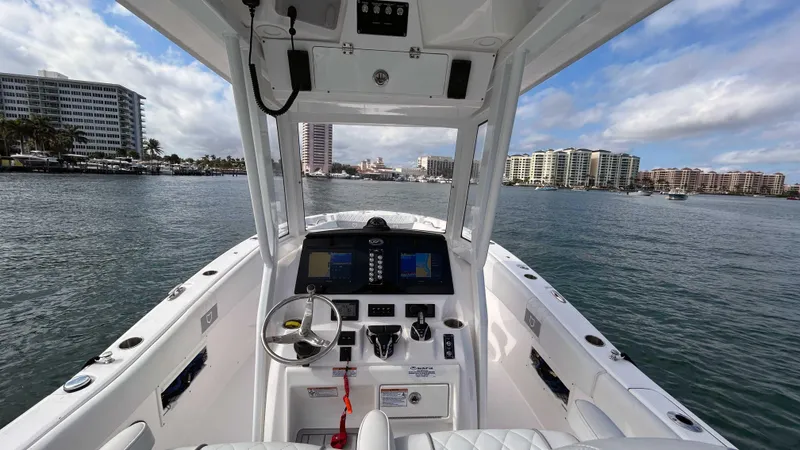 Slide: The Image of 2024 Sea Fox 268 Commander boat dashboard with city skyline in the background. - 14