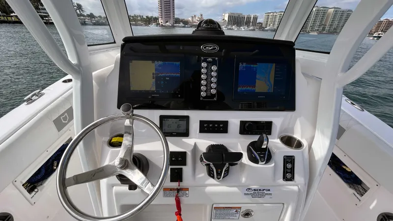 Slide: The Image of 2024 Sea Fox 268 Commander boat dashboard with navigation screens and controls. - 15