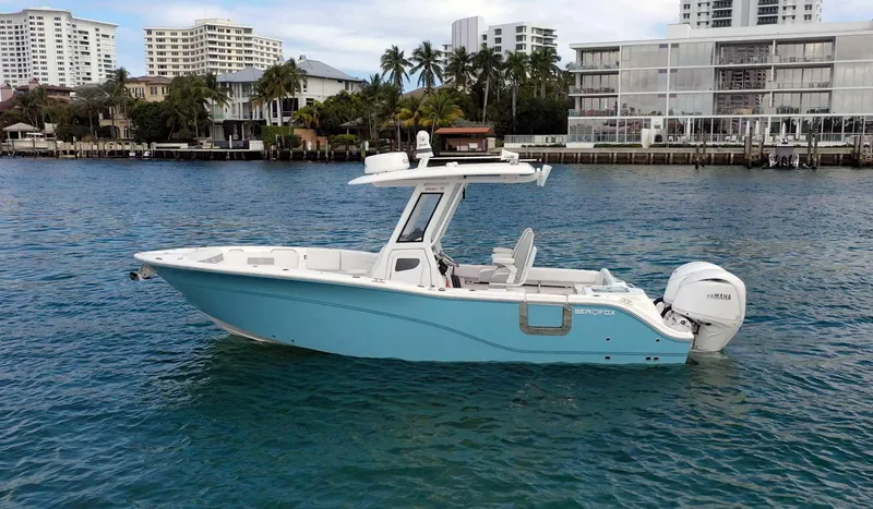 Slide: The Image of 2024 Sea Fox 268 Commander boat on water, with cityscape background. - 2